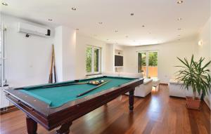 a pool table in a large living room with at Awesome Home In Sinj With Sauna in Sinj