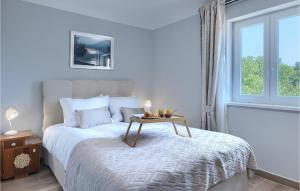 a bedroom with a bed with a table on it at Villa Stora Kuca in Krapan