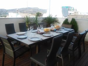 a table with glasses and plates on it on a patio at Casa Caballero de la Rosa in Priego de Córdoba