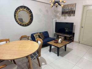 a living room with a table and a tv at Camella Northpoint Property near SMX Convention in Davao City