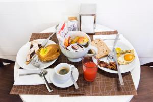 a table with plates of breakfast food on it at Domus Trevi in Rome