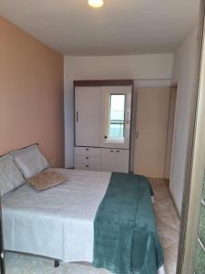 a bedroom with a bed and a window at Apartamento 2 quartos - Em frente a praia in Saquarema