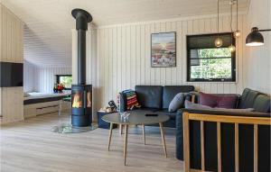 a living room with a couch and a fire place at Amazing Home In Hasle With Wifi in Hasle