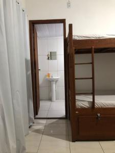 a bathroom with a bunk bed and a sink at Casa Vibra Luz Guest House Familiar in Florianópolis