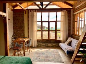 a living room with a couch and a table at Nativo Lodge in Playas +35 photos