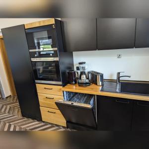 a kitchen with a sink and a counter top at MY TIME BLED Holiday House with sauna in Zgornje Gorje