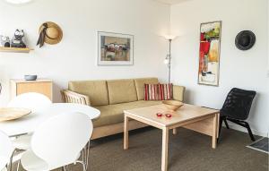 a living room with a couch and a table at Nice Apartment In Allinge in Allinge