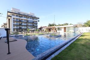 a large swimming pool in front of a building at Estúdio completo recém inaugurado com linda vista! in Niterói
