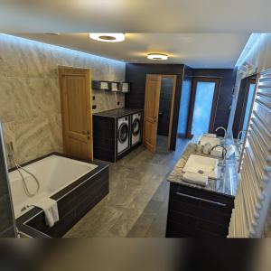 a large bathroom with a tub and a sink at MY TIME BLED Holiday House with sauna in Zgornje Gorje +37 photos