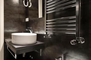 a bathroom with a white sink on a counter at Residenza Edoardo I in Rome