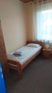 a bed in a room with a window at Haus Sieberns Haus Sieberns in Norderney