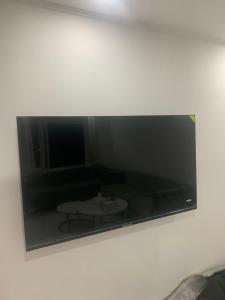 a mirror on a wall with a living room at Appartement in Saint-Martin-de-Valgalgues