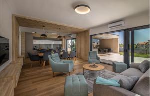 a living room with couches and chairs and a table at Villa La Reina Brtonigla in Brtonigla