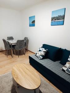 a living room with a couch and a table at Aurum29 in Doboj