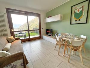 a living room with a table and a dining room at Belvedere in Costa - Lake View in Bellano
