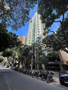 a row of motorcycles parked on the side of a street at Volpi Residence Savassi - VIP - Sinta-se em casa in Belo Horizonte