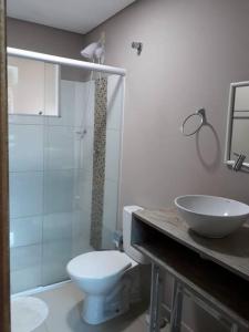 ボンビーニャスにあるCasa Bombinhas Com Piscinaの白いトイレと洗面台のあるバスルーム