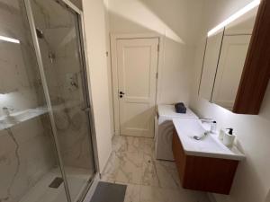 a bathroom with a shower and a sink and a mirror at Augusta Luxury Apartment - near praça do comércio in Lisbon