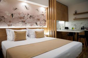 a bedroom with a bed with a wall with butterflies at Nebula Apartments in Tirana