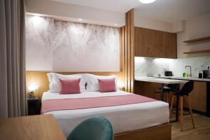 a hotel room with a bed and a desk at Nebula Apartments in Tirana