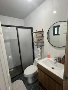 a bathroom with a toilet and a sink and a mirror at Cabaña de campo pequeña in Los Ángeles