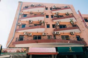 a tall building with balconies and air conditioners on it at Hotel Apart HLB in Marrakesh +9 photos
