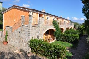 a building with a balcony on the side of it at Residence Baia Infreschi in Marina di Camerota
