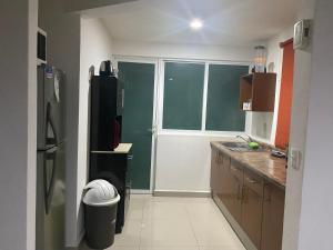 a kitchen with a black refrigerator and a window at Apartamento inn cancun in Cancún +2 photos