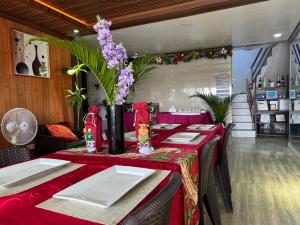 a dining room with a table with a red table cloth at Phuenics de galera in Puerto Galera