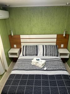 a bedroom with a bed with a shirt on it at Recanto das Araucárias - Carazal, Gramado. in Gramado