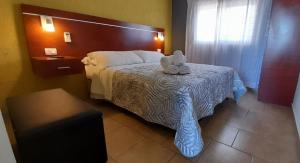 a bedroom with a bed with a stuffed animal on it at Amanecer Petit in Miramar