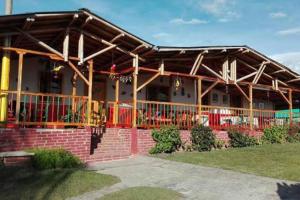 a house with awning on the side of it at Finca en el Quindío - Arrullo Cafetero in Quimbaya