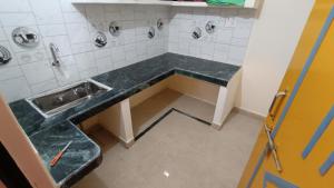 a bathroom with a sink and a counter at Aasiyana Homes in Rāmnagar