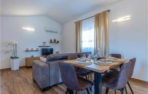 a living room with a table and a couch at Nice Home In Sestanovac With Kitchen in Šestanovac