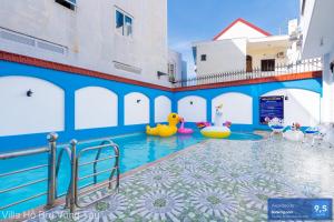 a swimming pool with inflatables in a building at Villa Sân Vườn Gần Biển Bãi Sau - Free Bida - Dàn Karaoke in Vung Tau