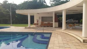 a house with a swimming pool with a pavilion at Apartamento Manaus Arena da Amazonia in Manaus