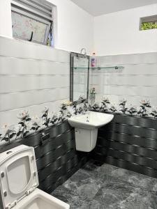 a bathroom with a toilet and a sink at VN45 Villa in Ahangama in Ahangama