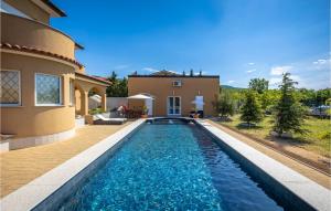 a swimming pool in front of a house at Awesome Apartment In Smrika With Wifi in Šmrika