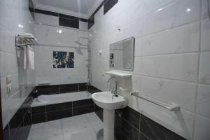 a white bathroom with a sink and a bath tub at 埃及江南人家 in Cairo