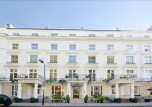 un gran edificio blanco con ventanas y balcones en The Premier Notting Hill en Londres