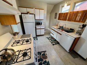 a kitchen with a stove and a white refrigerator at Comfy Cozy Bungalow Suite 2 10 min from Downtown in Cincinnati
