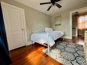a bedroom with a bed and a rug at Comfy Cozy Bungalow Suite 2 10 min from Downtown in Cincinnati +8 photos