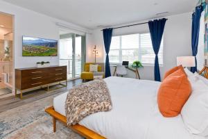 a bedroom with a large white bed and a desk at Armonia89- Villa Lago Dream Lakefront Pool Luxury 4BR Oasis in Indio +61 photos