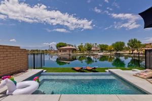 a swimming pool in the middle of a yard at Armonia89- Villa Lago Dream Lakefront Pool Luxury 4BR Oasis in Indio