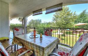 a porch with a table and chairs on a balcony at Apartment Mugeba I in Poreč