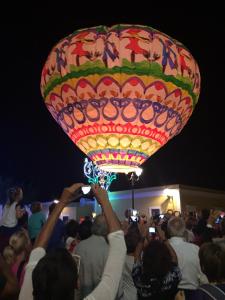 a crowd of people taking pictures of a hot air balloon at Hotel Mezzatorre in Ventotene
