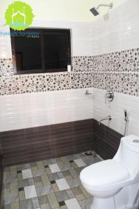 a bathroom with a toilet and a window at Thekkady Homestay in Thekkady +42 photos