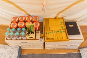 a group of plastic containers filled with drinks and a laptop at TP-HOMES PHAN THIẾT in Phan Thiet
