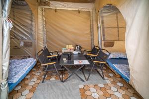 a room with a table and chairs in a tent at TP-HOMES PHAN THIẾT in Phan Thiet