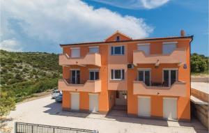an orange house in a parking lot at Cozy Apartment In Sevid With Wifi in Sevid